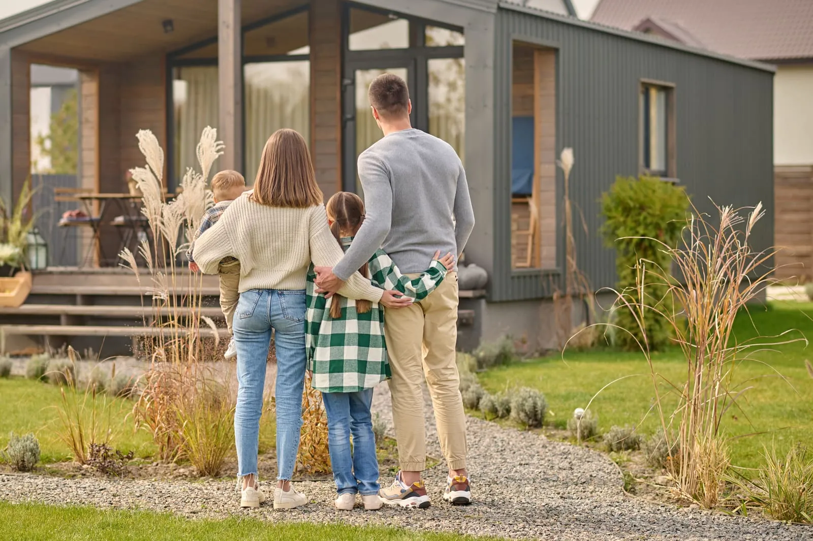A family admiring their newly remodeled home exterior in the DMV