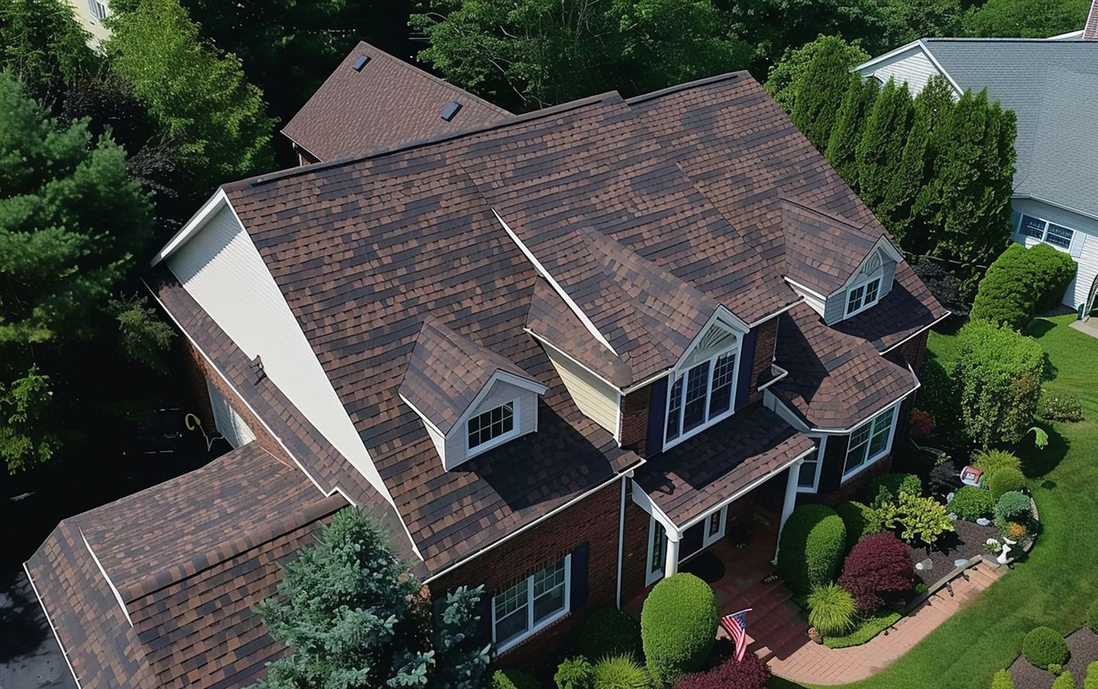 Aerial view of a finished architectural shingle roof on a large home