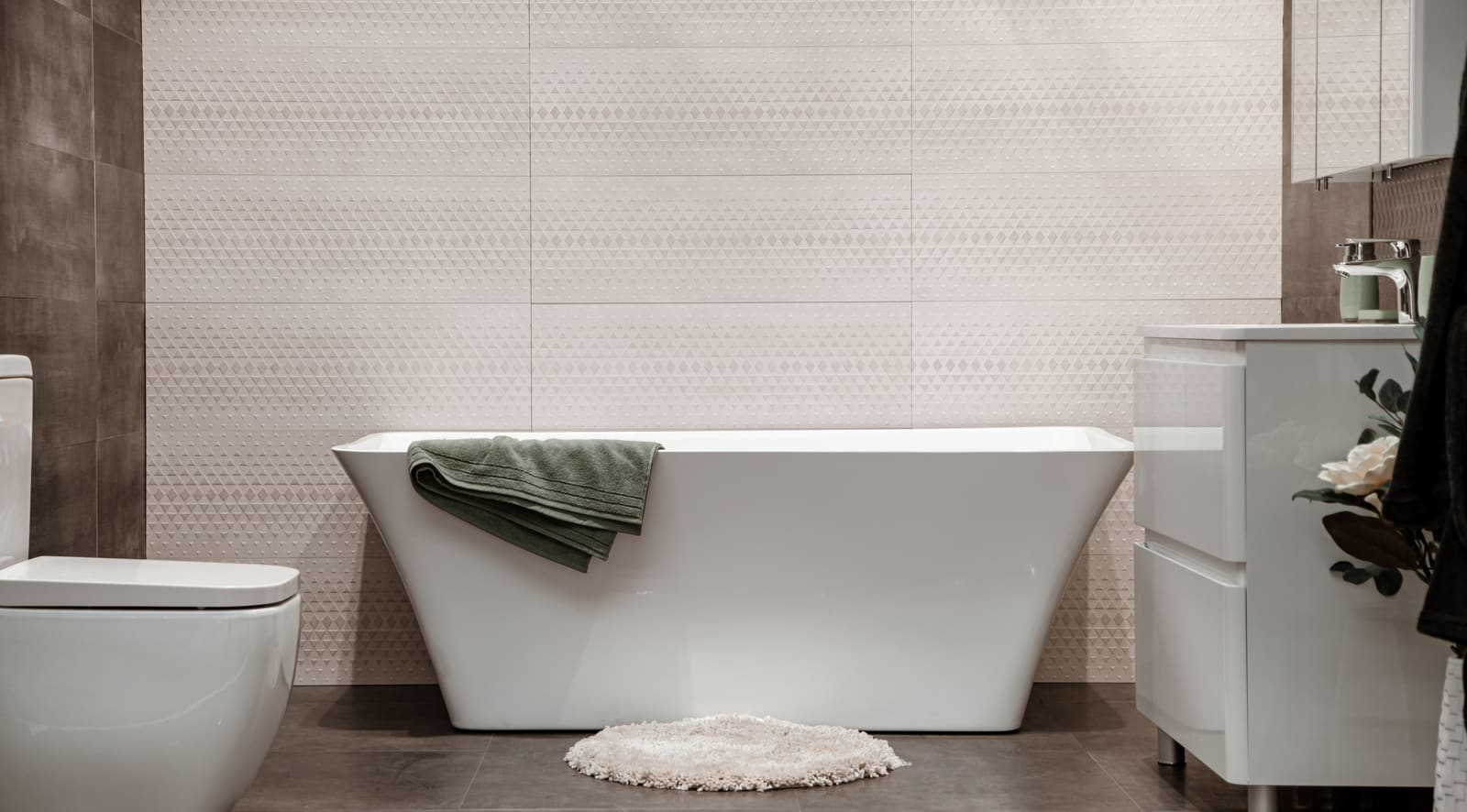 Modern remodeled bathroom with a freestanding tub, neutral tile, and clean fixtures